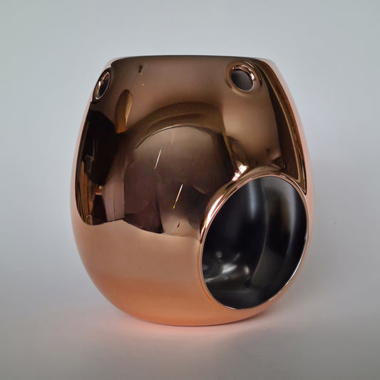 Een geurbrander voor waxmelts in de kleur rosé goud, spiegel.